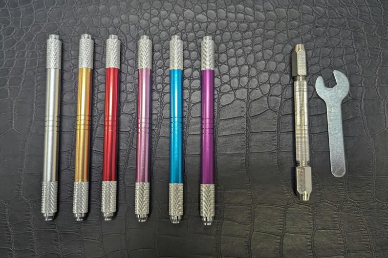 Alt text: Various vise pin options displayed, including hand-tightened and wrench-tightened styles in different colors and designs for interchangeable quilling needles.