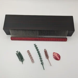 Professional stainless steel quilling comb with dual rows of metal teeth, shown in multiple colors on white background