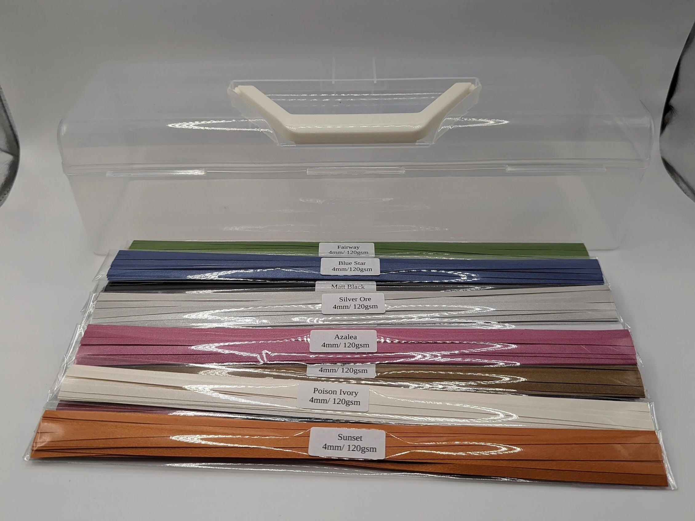 Assorted packs of 120 GSM midweight quilling paper strips in matte and pearl finishes with bonus vellum paper and plastic carrying case