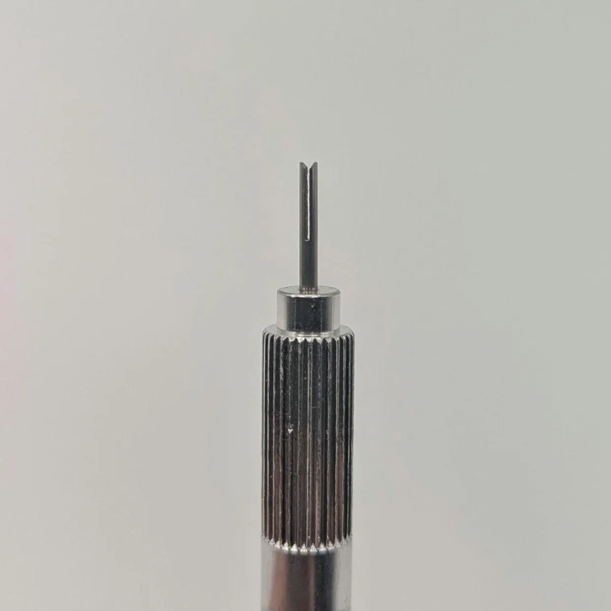 Close-up view of guided channel quilling needle tip with ergonomic grip