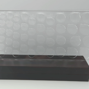 Clear acrylic circular quilling mold with multiple round wells in varying sizes, arranged across a rectangular template. Designed for making uniform loose coils with a built-in notch for easy coil removal.