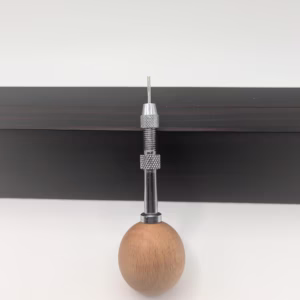 1.3 mm swivel head quilling needle with standard or guided tip. Ergonomic ball handle, vise pin system, and tabletop holder for precision and comfort.