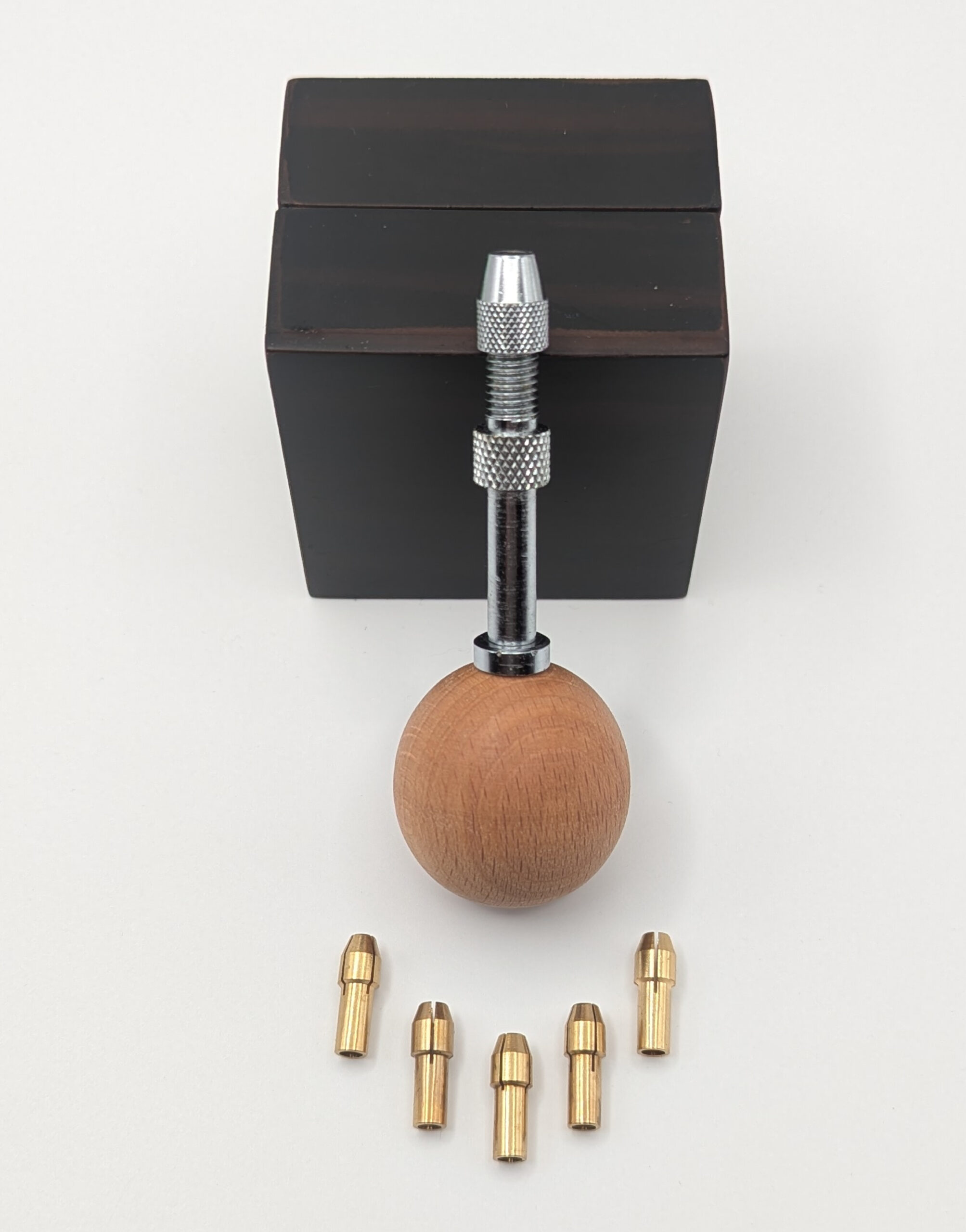 Swivel-headed ball handle for interchangeable quilling needles, shown with five metal housings arranged in a row.